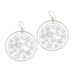 Concentric circles on silver ear wires contain dozens of sterling silver flower blossoms of various sizes and shapes in this pair of earrings from Indonesia's Candradewi. The artist who hails from Celuk--a Balinese village renowned for its gold and silver jewelry--uses silver wire to craft each petal. Spring Sterling Silver Earrings, Silver Flower Shaped Earrings For Spring, Silver Flower Earrings For Spring, Sterling Silver Flower Hoop Earrings For Pierced Ears, Silver Drop Earrings For Spring, Spring Nickel-free Silver Earrings, Silver Sterling Flower Earrings, Spring Sterling Silver Dangle Jewelry, Sterling Silver Dangle Jewelry For Spring