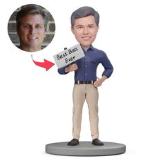 a bobble head with a man holding a sign that says best boss ever on it