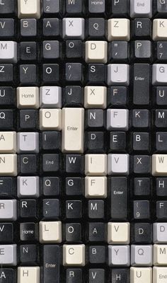 an old computer keyboard with white keys and letters on the back side, in black and white