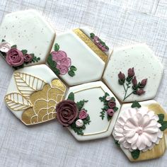 decorated cookies arranged in the shape of hexagons with flowers and leaves on them