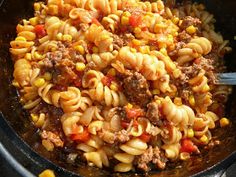 a skillet filled with pasta and ground beef