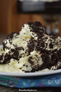 a white plate topped with ice cream and oreo cookies