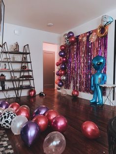 the room is decorated with balloons and streamers