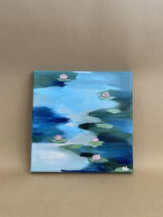 a painting of water lilies floating on top of a lake