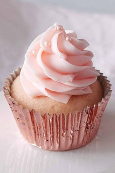 a cupcake with pink frosting on top