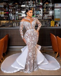 a woman standing in front of a bar wearing a wedding dress