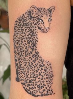 a black and white photo of a cheetah tattoo