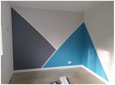 an empty room with blue and white walls