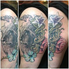 the tattoo on this woman's thigh shows an image of a lion and flowers