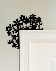 a white door with some black flowers on it