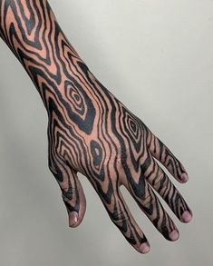 a hand with black and white designs on it