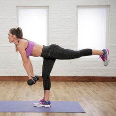 a woman doing an exercise on a yoga mat with dumbbells in her hands