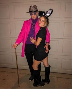 two people dressed up in costumes standing next to each other