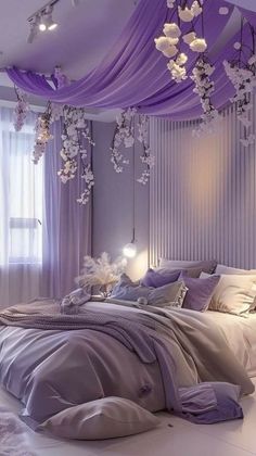 a bedroom with purple and white decor on the ceiling, bed linens in front of window