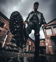 a man standing on top of a puddle of water