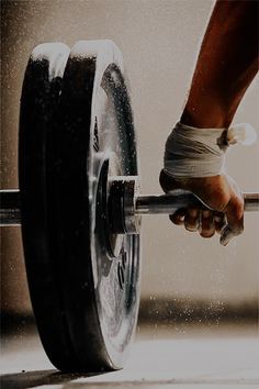 a person holding a barbell in their hand