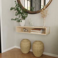 there is a mirror on the wall next to two stools and a vase with plants in it