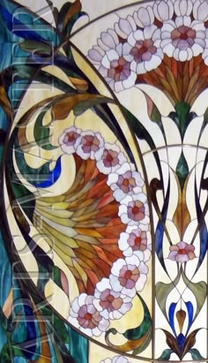 an artistic stained glass window with flowers and leaves