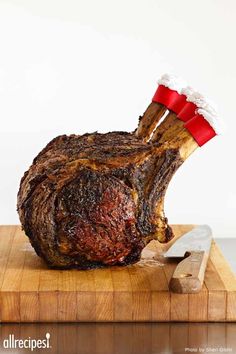 a large piece of meat sitting on top of a wooden cutting board