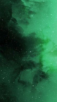 the sky is filled with green and white stars