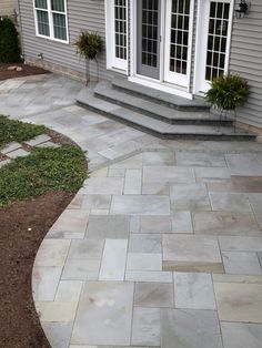 an outdoor patio with steps leading to the front door