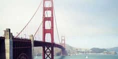 the golden gate bridge in san francisco, california with sailboats on the water below