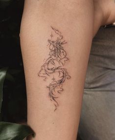 a woman's arm with a tattoo on it that has a dragon in the middle