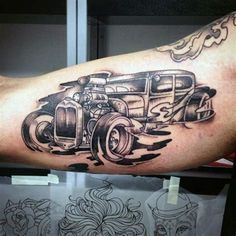 an old fashion car tattoo on the arm