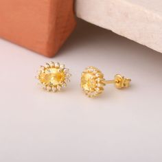 Illuminate your jewelry collection with our stunning Stud Oval Yellow Topaz Birthstone Earrings, a perfect blend of elegance and quality. Expertly crafted from 14K solid gold, these luxurious earrings feature a brilliant oval yellow topaz, surrounded by sparkling real diamonds that enhance their radiant glow. The warm hue of the yellow topaz symbolizes joy and positivity, making these earrings a delightful gift choice for birthdays, Christmas, or any special occasion. Designed to be worn every d Luxury Oval Earrings For May Birthstone, Yellow Gold Oval Halo Earrings, Gold Oval Halo Earrings, Oval Gold Halo Earrings, Oval Birthstone Earrings In Cubic Zirconia, Oval Cubic Zirconia Birthstone Earrings, Oval Gold Topaz Earrings, Oval Topaz Earrings For Anniversary, Luxurious Earrings