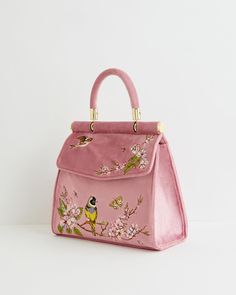 Key Features



Chic Spring Style: Embrace the essence of Spring with our Bird Embroidered Mini Tote, featuring nature-inspired embroidery and plush velvet finish.


Versatile Carryall: Perfect for any occasion, from workdays to special outings, ensuring you're prepared with effortless style.


Practical Design: Includes a convenient chain strap and secure popper fastening for easy access and peace of mind.


Compact Yet Spacious: Ample room for all essentials, measuring approximately 20cm L x 1