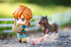 a small figurine is standing next to a horse