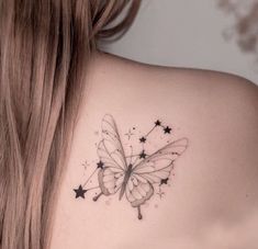 a woman's back shoulder with a butterfly and stars tattoo on her left shoulder