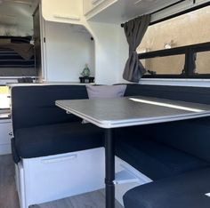 the inside of an rv with tables and chairs