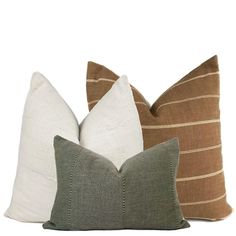 three different colored pillows sitting next to each other