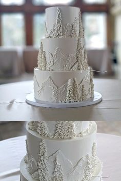 three tiered wedding cake with white frosting and pine trees on the top layer