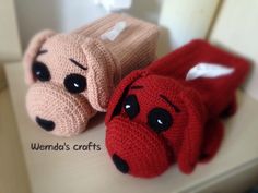 two knitted stuffed animals sitting on top of a table