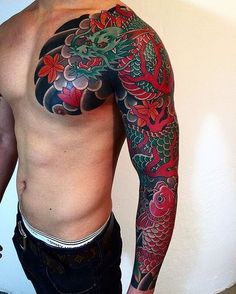 a man with a dragon tattoo on his arm and chest is standing in front of a white wall