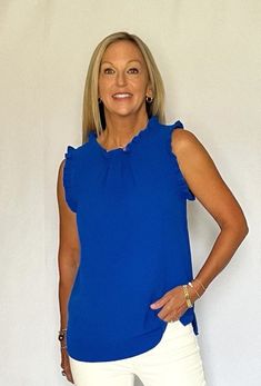 DESCRIPTION Sleeveless top with ruffle trim is perfect for game day or any day! The vibrant shade of royal blue is pretty in any season and a great versatile addition to your wardrobe. Side split hem. Back button keyhole closure. 100% polyester. SIZING INFO S/4-6 M/8-10 L/12-14 XL/16 Blue Sleeveless Top With Ruffle Hem, Side Split, Ruffle Top, Split Hem, Ruffle Trim, Game Day, Royal Blue, Sleeveless Top, Split