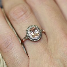 a close up of a person's hand with a ring on it