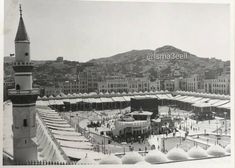 an old black and white photo of a city with snow on the ground in front of it