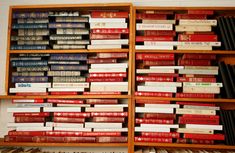 a book shelf filled with lots of books next to a wall full of books on top of each other