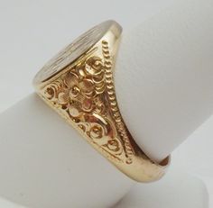 This is a really pretty signet ring from the Art Nouveau period. The ring has an oval signet area that measures 16 x 14 mm. The signet is already hand engraved with a monogram. The sides of the ring has a lovely carved floral design with a beaded edge. This ring is a nice size for either a man or a woman. The ring is stamped 14K and weighs 12.0 grams. The ring is engraved inside M B to P F. The ring is a size 10. *Sizing is available. Please message us for a quote* *We are always willing to ship Luxury Antique Engraved Filigree Ring, Luxury Antique Signet Ring With Single Cut Diamonds, Luxury Traditional Carved Rings, Luxury Antique Signet Ring Stamped 925, Luxury Vintage Signet Ring With Engraving Option, Floral Signet Ring, Luxury Vintage Signet Ring With Polished Finish, Luxury Vintage Signet Ring With Hallmarks, Luxury Silver Art Deco Signet Ring