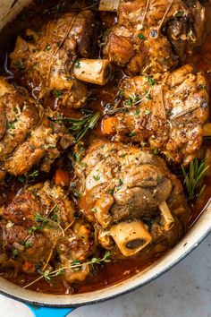 a pot filled with meat and vegetables on top of a table