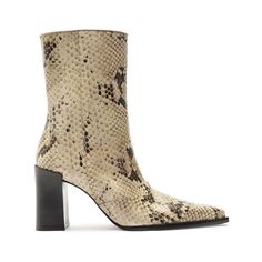 Our classic Raffaela bootie is crafted from quality leather. It features a snakeskin print, which will complete your outfits this Fall season and beyond. This bootie's pointed-toe and block heel amp up your midi skirts, jeans, and leggings to other heights, taking your outfit from casual to chic.Materials: Leather Upper | Leather OutsoleHeel Type: Mid HeelHeel Style: Block HeelToe Style: Pointed ToeClosure Type: Zipper ClosureCounter Type: ClosedShaft Height: 7.1 In | 180 mmShaft Circumference: 11.4 In | 290 mmHeel Height: 3,3 In | 85 mmSKU: S2187300010014 Snakeskin Booties Outfit, Red Booties, Booties Outfit, Olympia Le Tan, Chunky Block Heels, Clear Heels, Midi Skirts, Snakeskin Print, Shoes Booties