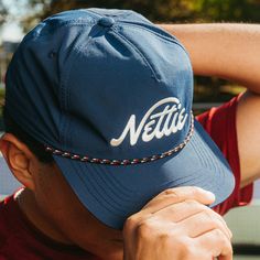 A pickleball hat that looks cool, keeps the sun out of your eyes, and can be worn on and off the court! FEATURES Performance Nylon Material Unstructured 5 Panel Mid Profile Crown Flat Pliable Bill Snapback Closure Embroidered Nettie logo Navy Adjustable Baseball Cap For Summer, Adjustable Snapback Hat With Embroidered Logo For Summer, Summer 5-panel Snapback Hat With Embroidered Logo, 5-panel Snapback Hat For Summer Sports, Summer Embroidered Logo 5-panel Snapback Hat, Summer 5-panel Snapback Hat For Sports Events, 5-panel Snapback Hat For Sports Events, Adjustable Sun Hat With Embroidered Logo And Curved Brim, 5-panel Snapback Hat For Sports Events In Summer