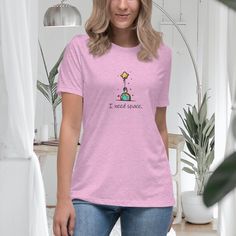 "Step into a world where whimsy meets interstellar dreams with our captivating women's relaxed t-shirt. This cosmic masterpiece showcases a delightful doodle astronaut, playfully reaching for the stars while clutching a vibrant balloon. With an air of enchantment and a touch of humor, the captivating design sends a message that resonates with every adventurous soul: \"I Need Space.\" Crafted with the finest blend of comfort and style, our t-shirt offers a relaxed fit that embraces your individuality and makes a bold statement. Its luxuriously soft fabric drapes effortlessly, providing a cozy feel that's perfect for casual outings or celestial escapades. The enchanting doodle astronaut captures the imagination, urging you to explore uncharted territories and embrace your inner wanderer. Whe Casual Look, Girls Tshirts, Womens Clothing Tops, Business Casual, Dress Pants, Unisex Hoodies, Outfit Of The Day, Casual Looks, Women's T Shirt