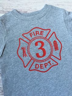 a fire department shirt with the number three on it