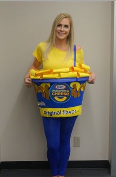 a woman in yellow shirt and blue leggings standing next to a bucket filled with ice cream