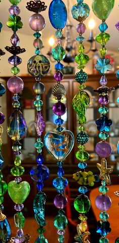 many different colored glass beads hanging from the ceiling