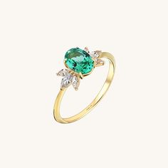 The Emerald Flower Ring will demonstrate your taste with its elegancy so that you can feel yourself more stylish and special at any time of the day with the Emerald Flower Ring, which will gather all the attentions around you with its sparkly marquise stones and glamorous stance of the unique centre stone. - Made in 14k solid gold - Decorated with handset lab grown emerald stone on 14k solid gold - Band Width: 1.43 mm / 0.056 inches- Stone Size: 5.93x7.10 mm / 0.233x0.279 inches- Thickness: 1.54 Luxury Rings With Marquise Accent Stones, Dazzling Diamond Ring With Gemstone Accents For Wedding, Luxury Marquise Rings With Accent Stones, Luxury Marquise Ring With Accent Stones, Marquise Emerald Ring With Center Stone, Dazzling Marquise Diamond Ring With Gemstone, Marquise Diamond Emerald Ring With Center Stone, Marquise Emerald Diamond Ring With Center Stone, Elegant Marquise Crystal Ring With Prong Setting